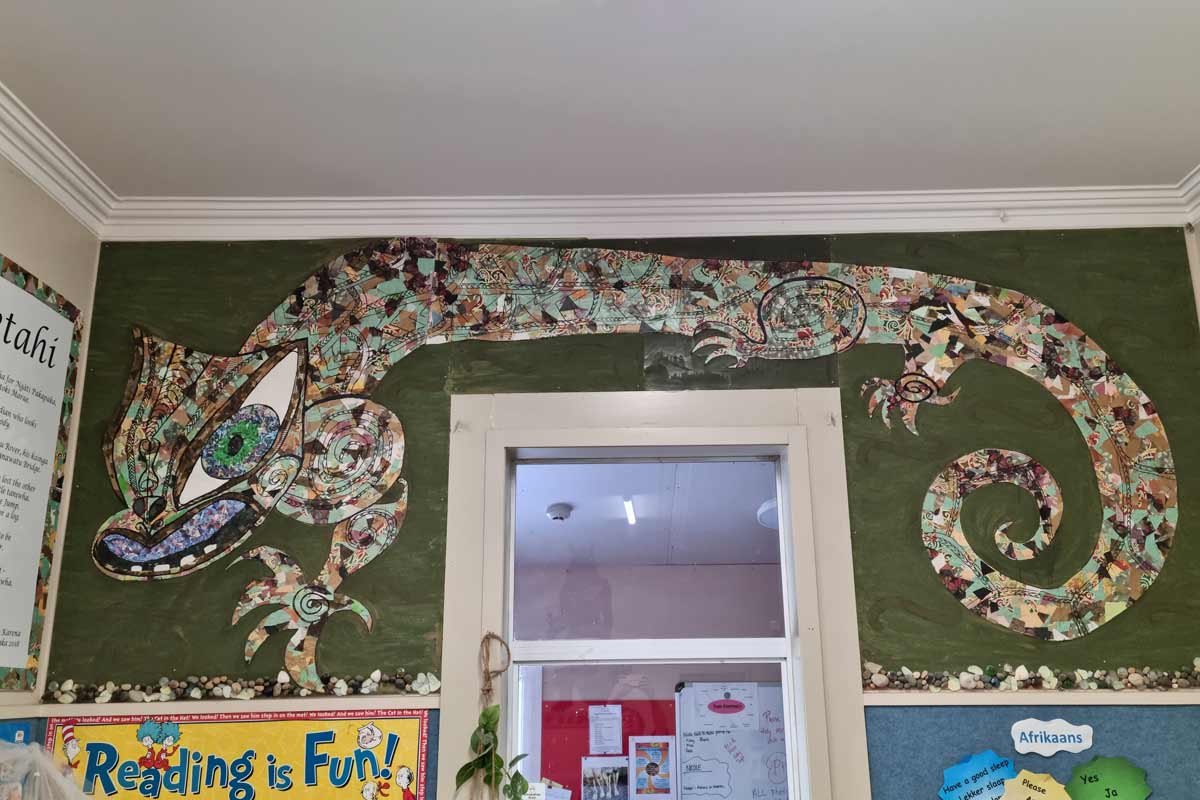 Artwork above the door of Peketahi the Taniwha. 