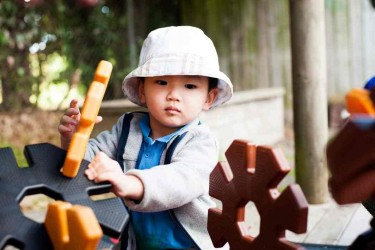 Child playing with outdoor building blocks. 