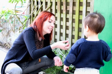 Adult and child looking at a plant. 