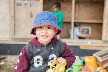 Child playing in a sandpit. 