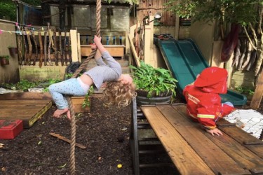 Child playing on a rope swing. 