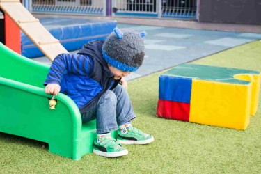 Child playing on a slide. 