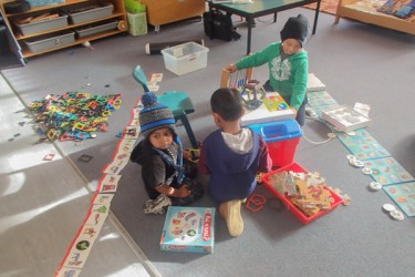 Children playing with puzzles and toys. 