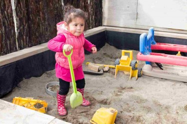 Child playing in a sandpit. 