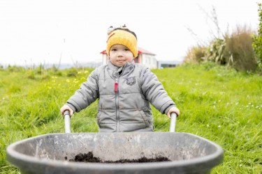 Child with a wheelbarrow. 